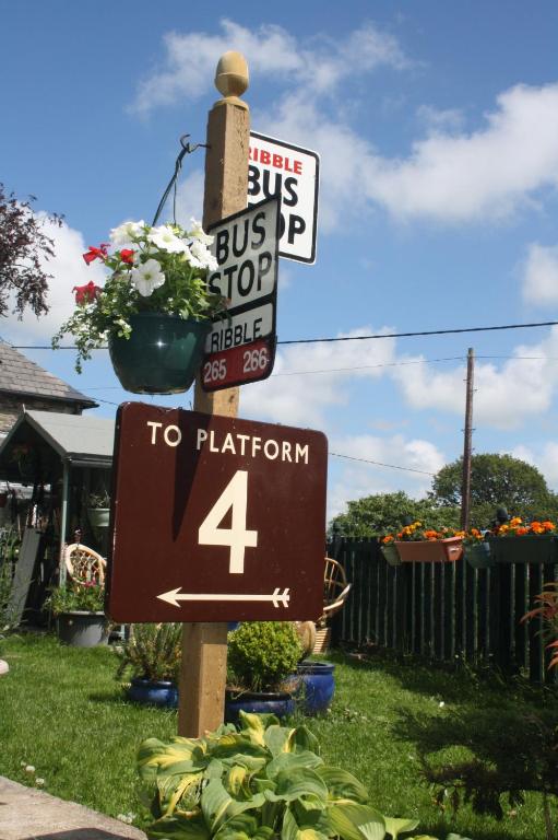 a sign for a bus stop and a to platform at Carraholly in Liskeard