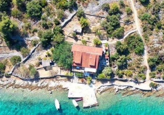 an aerial view of a house on an island in the water at Apartments Lučin in Drvenik Veli