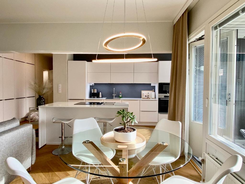 a kitchen and living room with a table and chairs at Borg Housing City Central in Pori