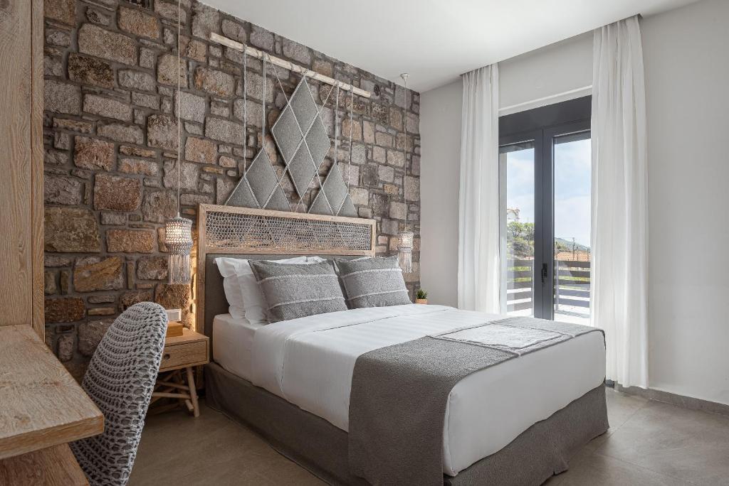 A bed or beds in a room at LemnosThea Luxury Villas