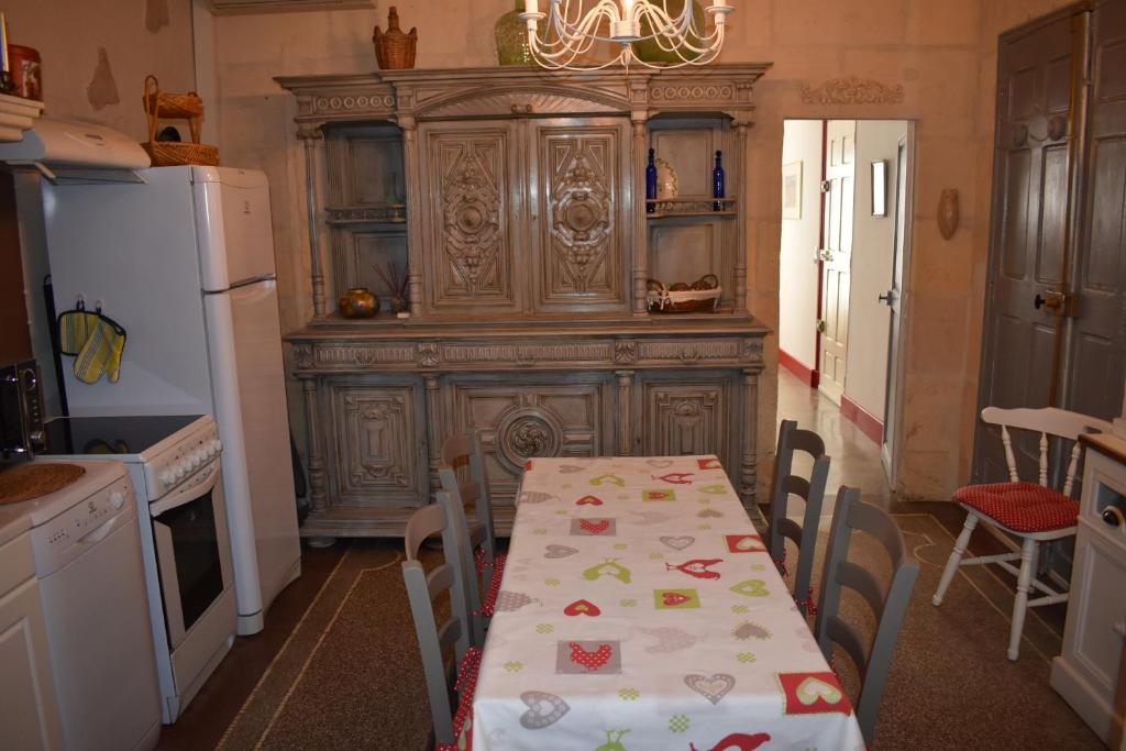 a kitchen with a table and a refrigerator at Maison ARUM - Arles, centre historique in Arles