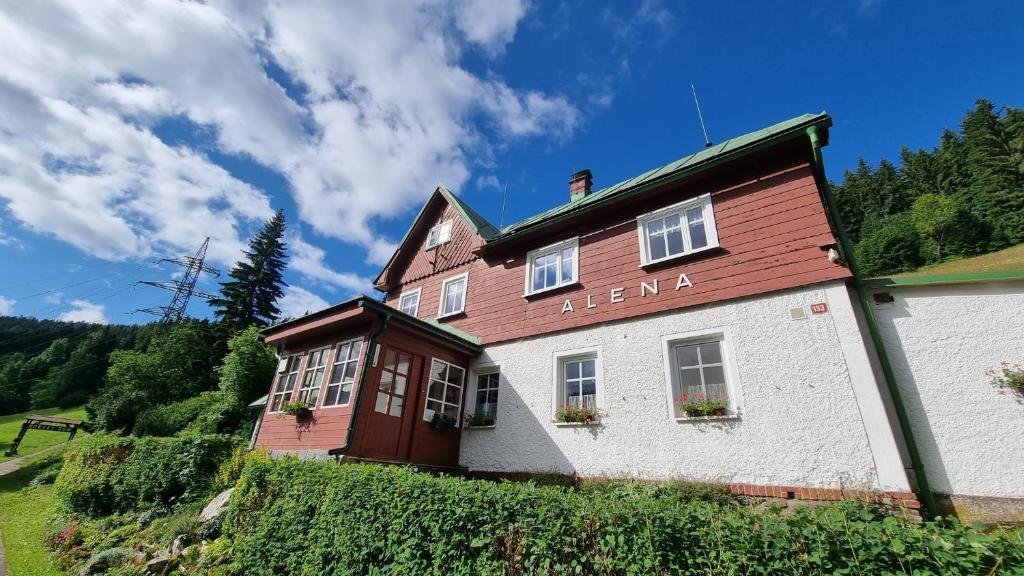 a building with a sign that says leena on it at Penzion ALENA in Pec pod Sněžkou