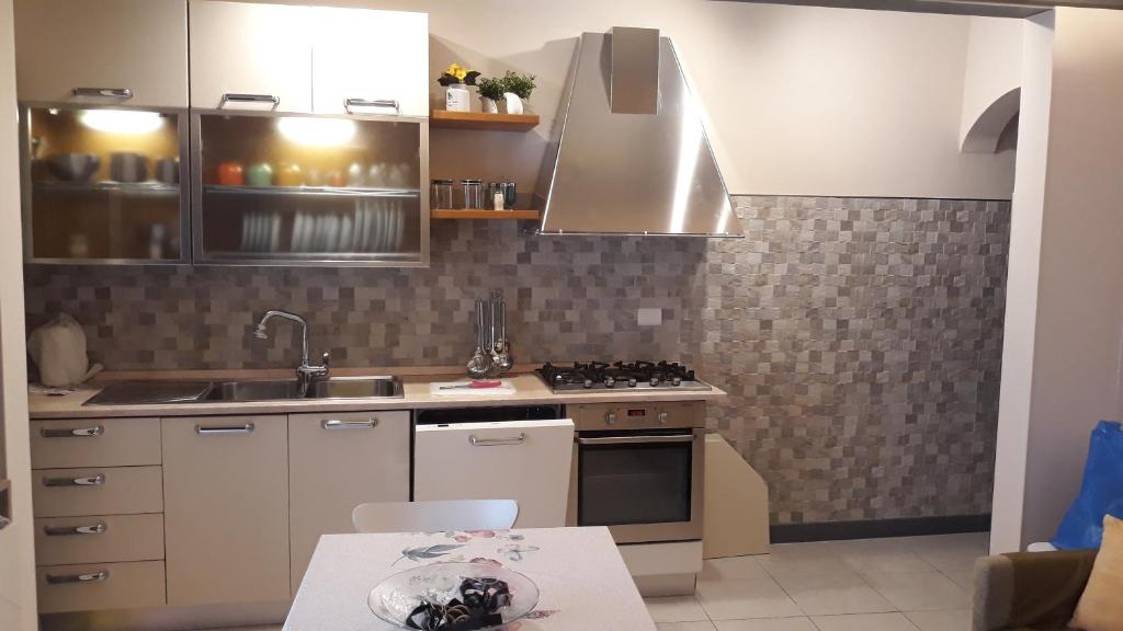 a kitchen with a sink and a stove top oven at LA DIMORA DI MARIA in Ortona
