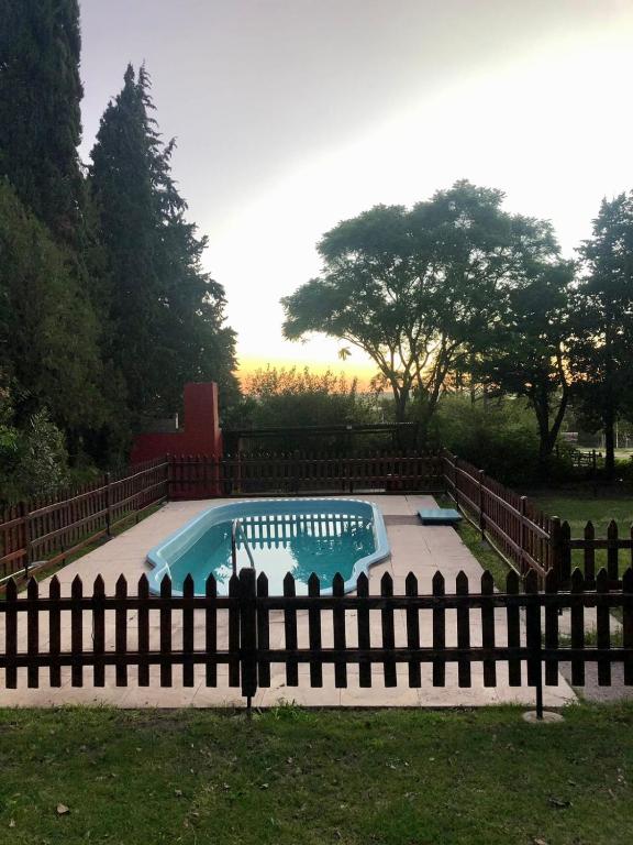a swimming pool in a yard behind a fence at La Vieja Calera in Victoria
