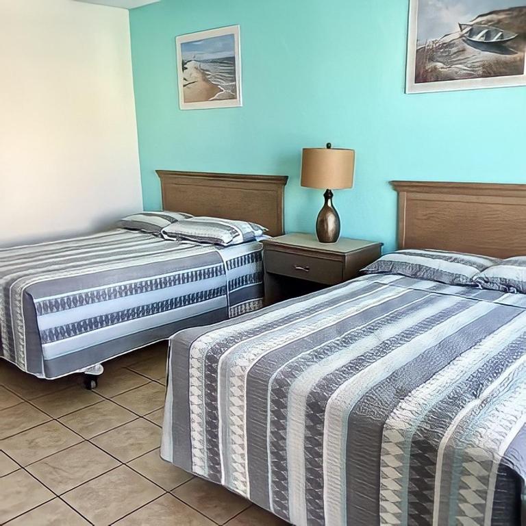 Postel nebo postele na pokoji v ubytování Beach Colony Motel