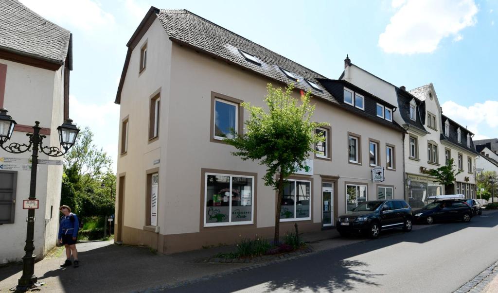 a man standing in front of a building on a street at Der Eifel Perle Manderscheid in Manderscheid