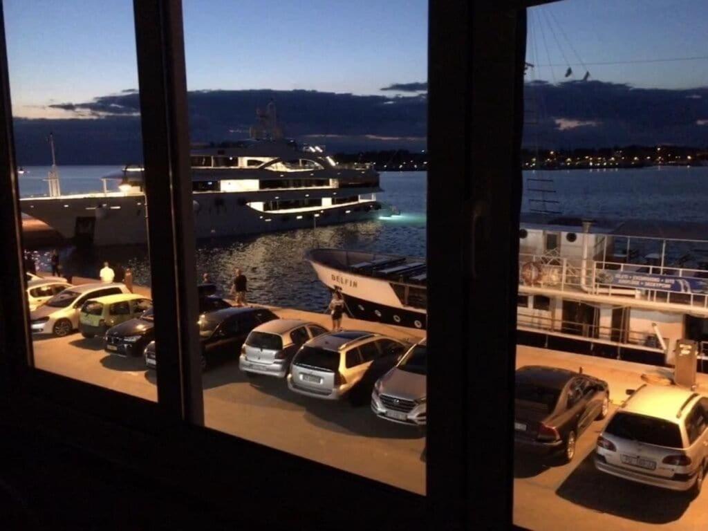 a view from a window of a marina with cars parked at Apartment Bellavista - Umag in Umag