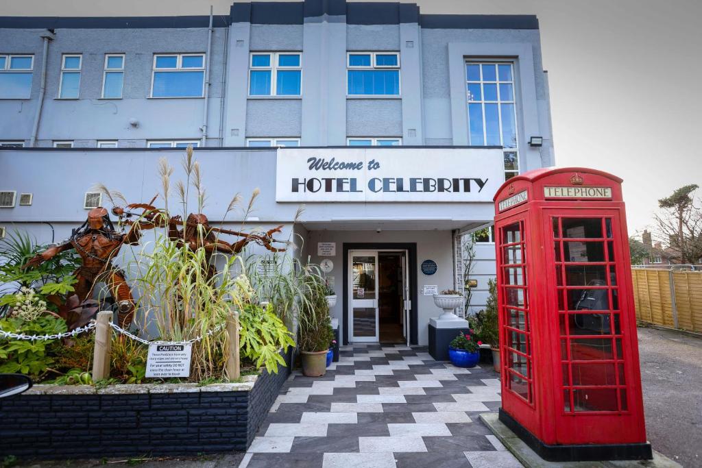 a red phone booth and a building with a hotel clinic at Hotel Celebrity in Bournemouth