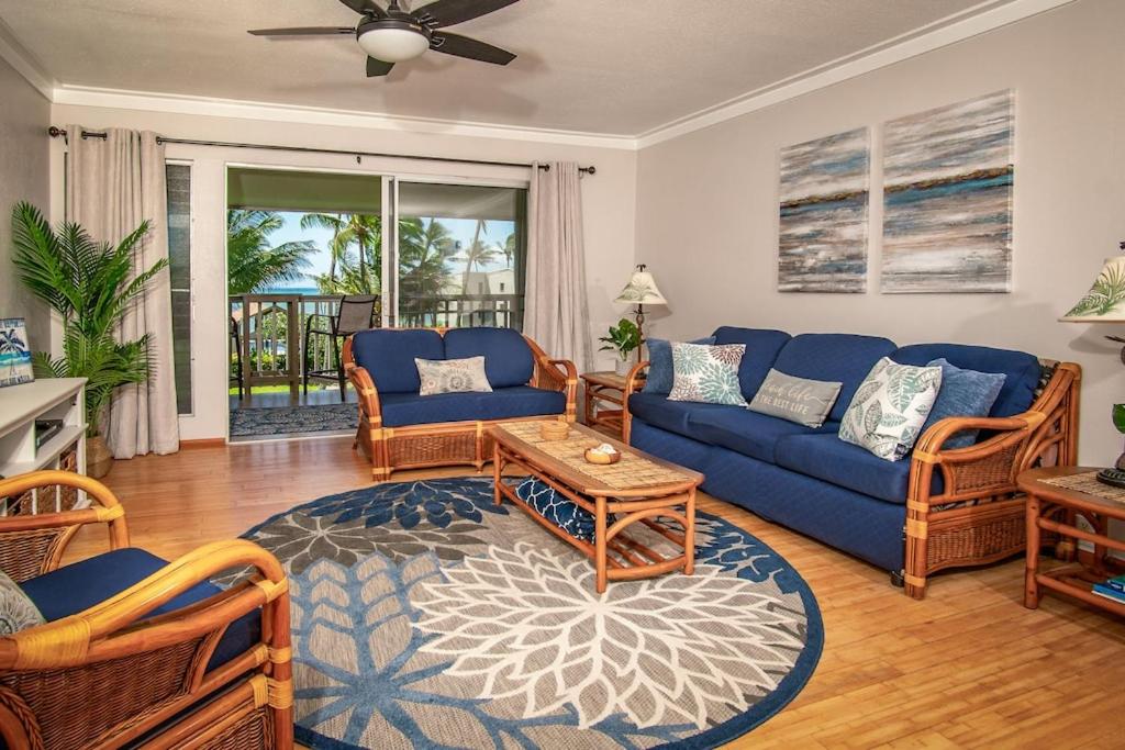 a living room with a blue couch and chairs at Molokai Island Retreat with Beautiful Ocean Views and Pool - Newly Remodeled! in Ualapue