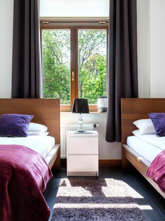 Posteľ alebo postele v izbe v ubytovaní CracWoW VIP Apartment
