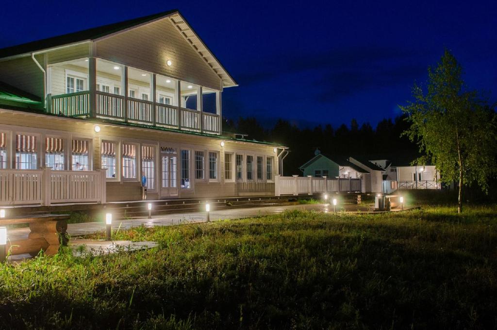 a house with lights in the yard at night at Staraya Sloboda Hotel in Staraya Sloboda