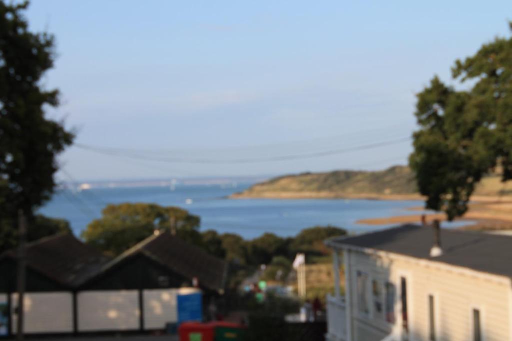 a view of a body of water from a house at luxury new 3 bed caravan with stunning sea view on private beach in Thorness bay in Porchfield