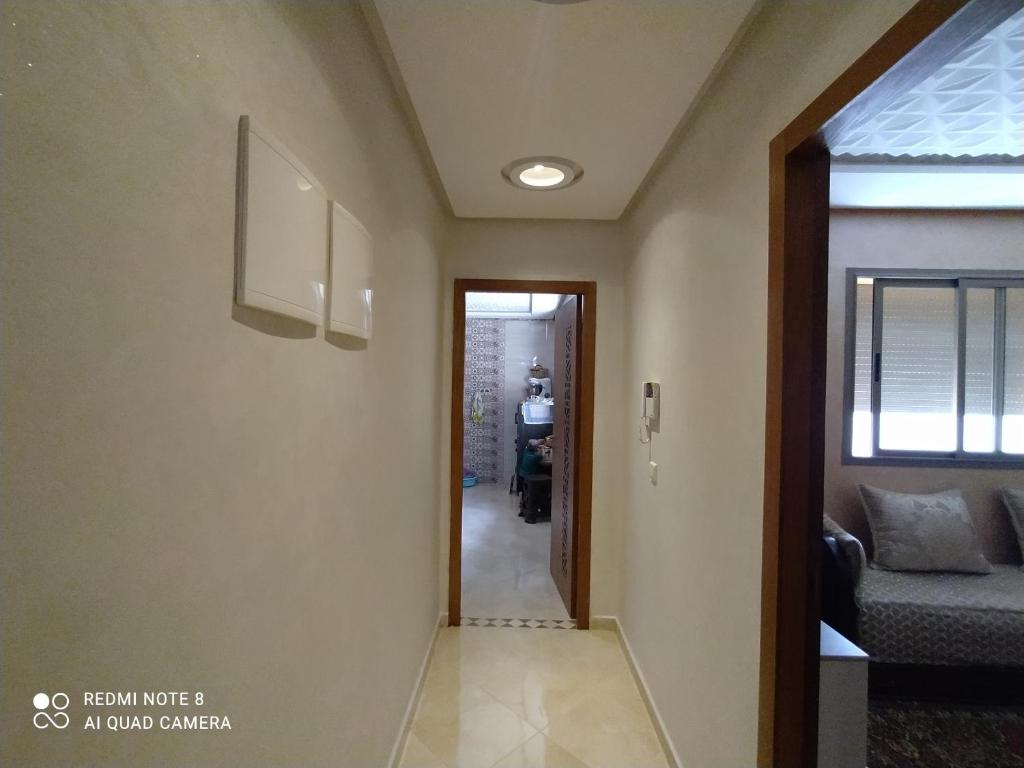 a hallway with a door leading to a living room at Appartement à Bouznika prêt du plage Dahomey, plage bouznika, Bahia beach in Bouznika