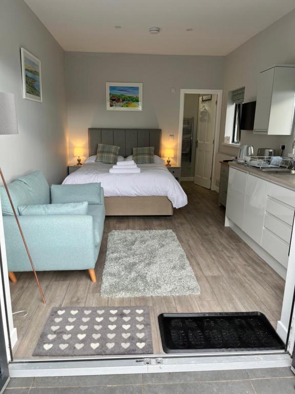 a living room with a bed and a couch at Fyrish View in Dingwall