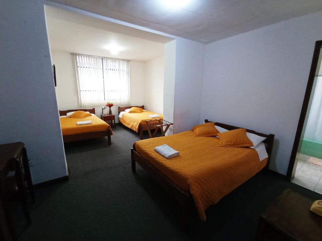 Postel nebo postele na pokoji v ubytování Hotel 9 de Octubre