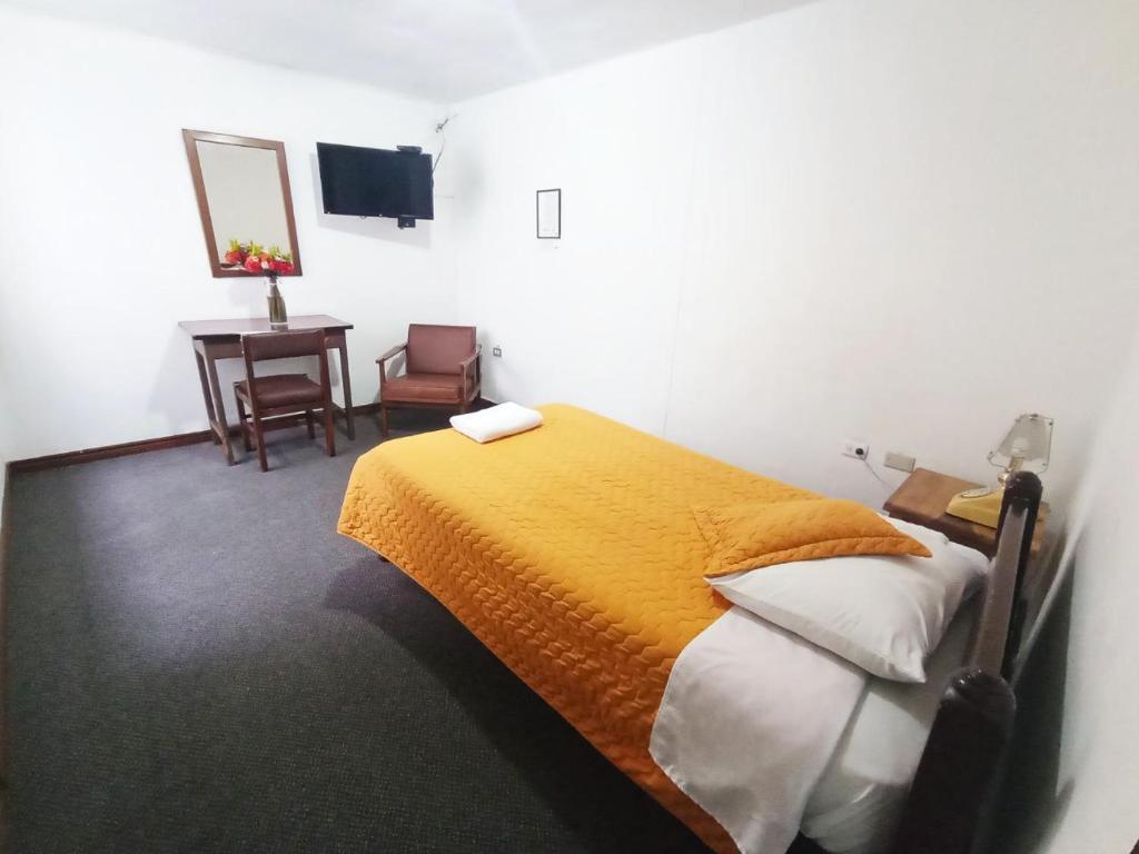 Postel nebo postele na pokoji v ubytování Hotel 9 de Octubre