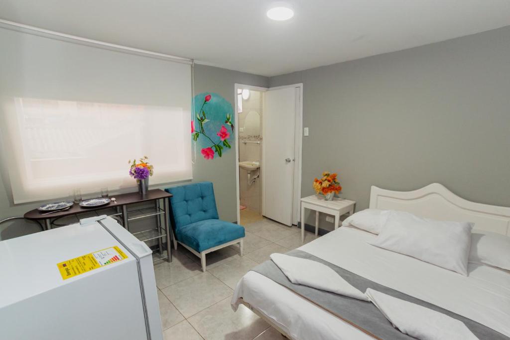 Postel nebo postele na pokoji v ubytování ApartaSuites & Hotel Bogota Teusaquillo