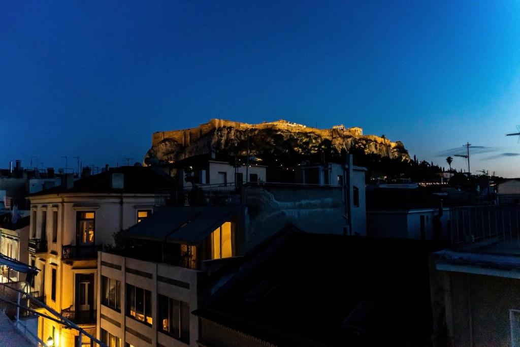 a view of a mountain at night with buildings at Luxury penthouse , breathtaking Acropolis view in Athens