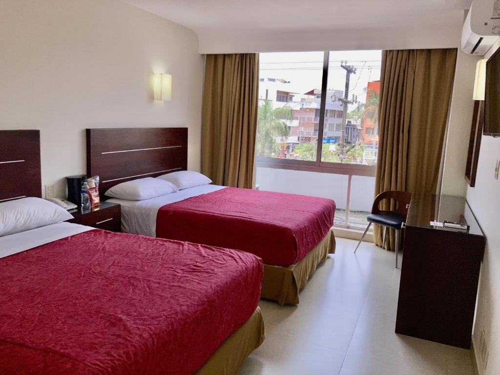 Postel nebo postele na pokoji v ubytování May Palace Hotel 