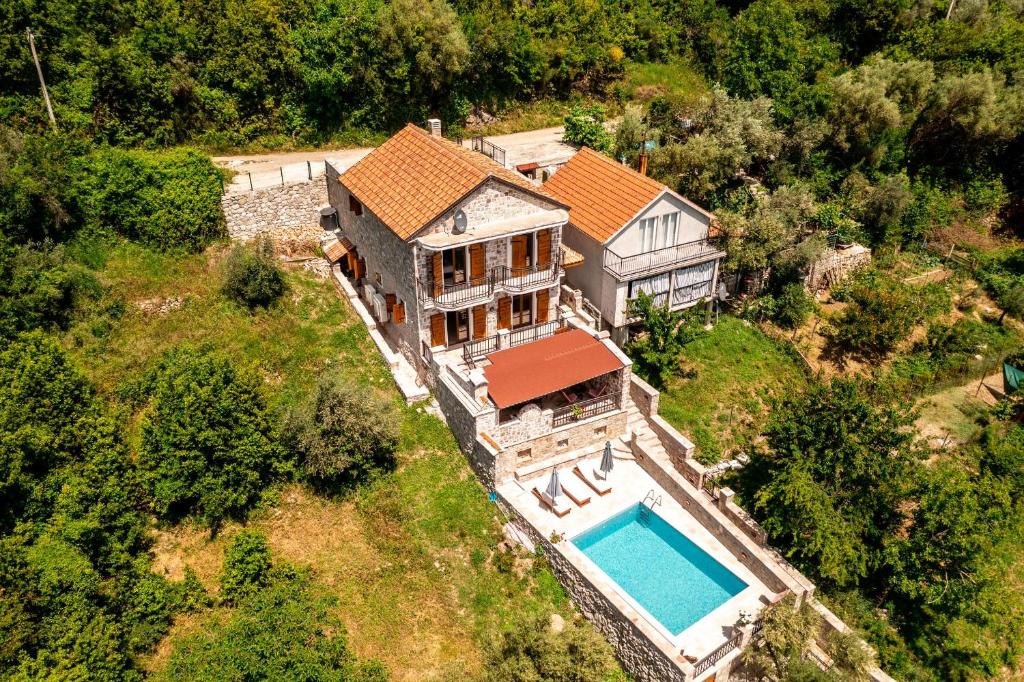 an aerial view of a house with a swimming pool at Old Stone House Villas in Tivat