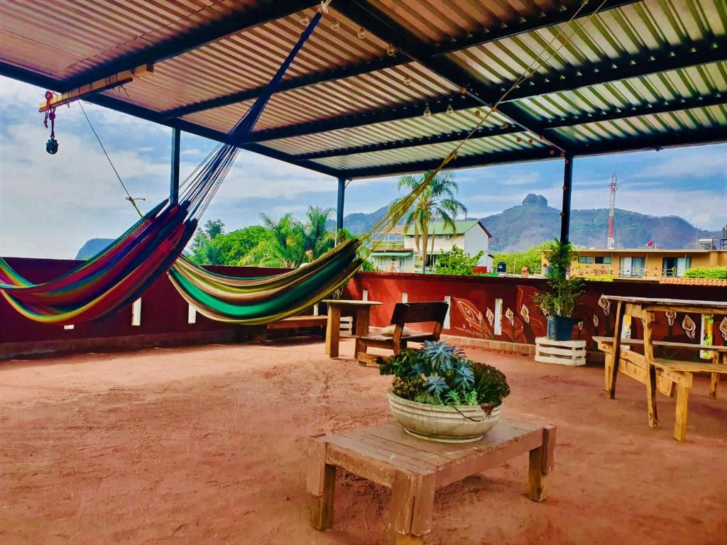un patio con hamacas, mesa y sillas en Mi Atardecer en Tepoz, Hostal en Tepoztlán