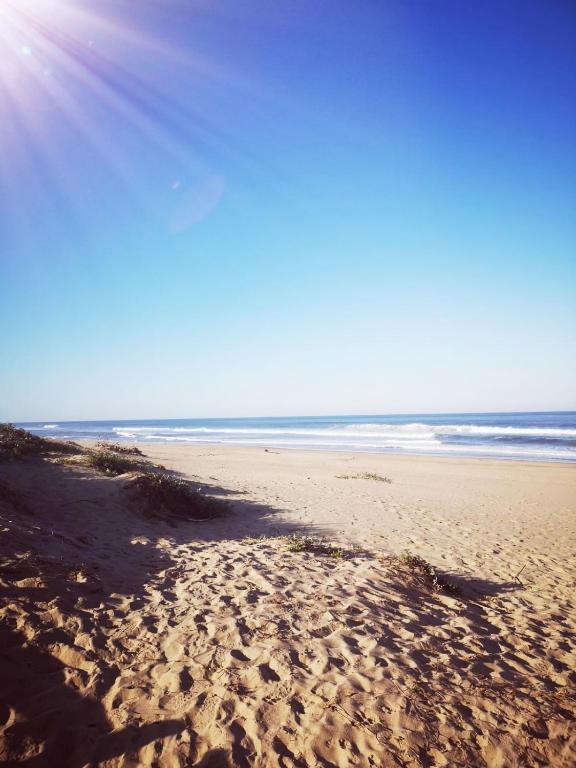 a sandy beach with the ocean in the background at 65 @ Zeezicht in Kingsborough