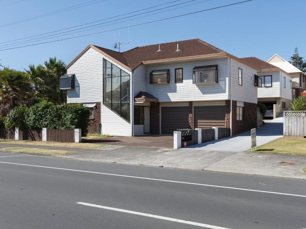 a house on the side of a street at At The Bay - Mt Maunganui Holiday Home in Matapihi