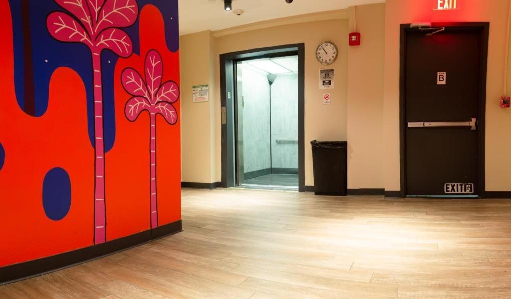 an office lobby with a door with a painting on the wall at Jazz on Columbus Circle Hostel in New York