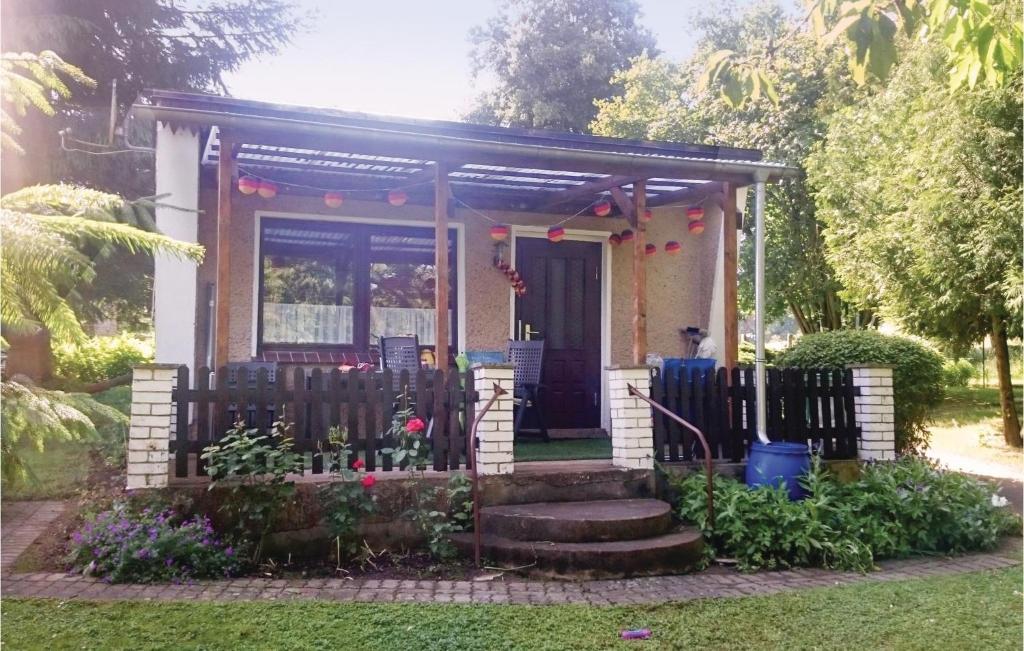 a small house with a gate and a porch at Cozy Home In Sagsdorf With Kitchenette in Sternberg