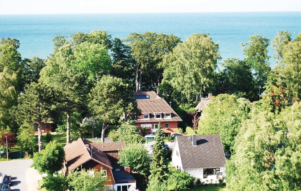 an aerial view of a house with trees and the ocean at Beautiful Apartment In Hohwacht With Kitchen in Hohwacht