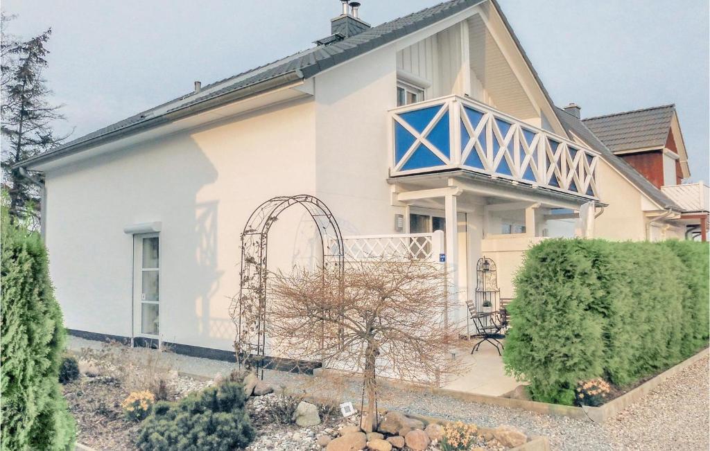 a house with an arbor on the front of it at Haus Seeadler 5 in Süssau