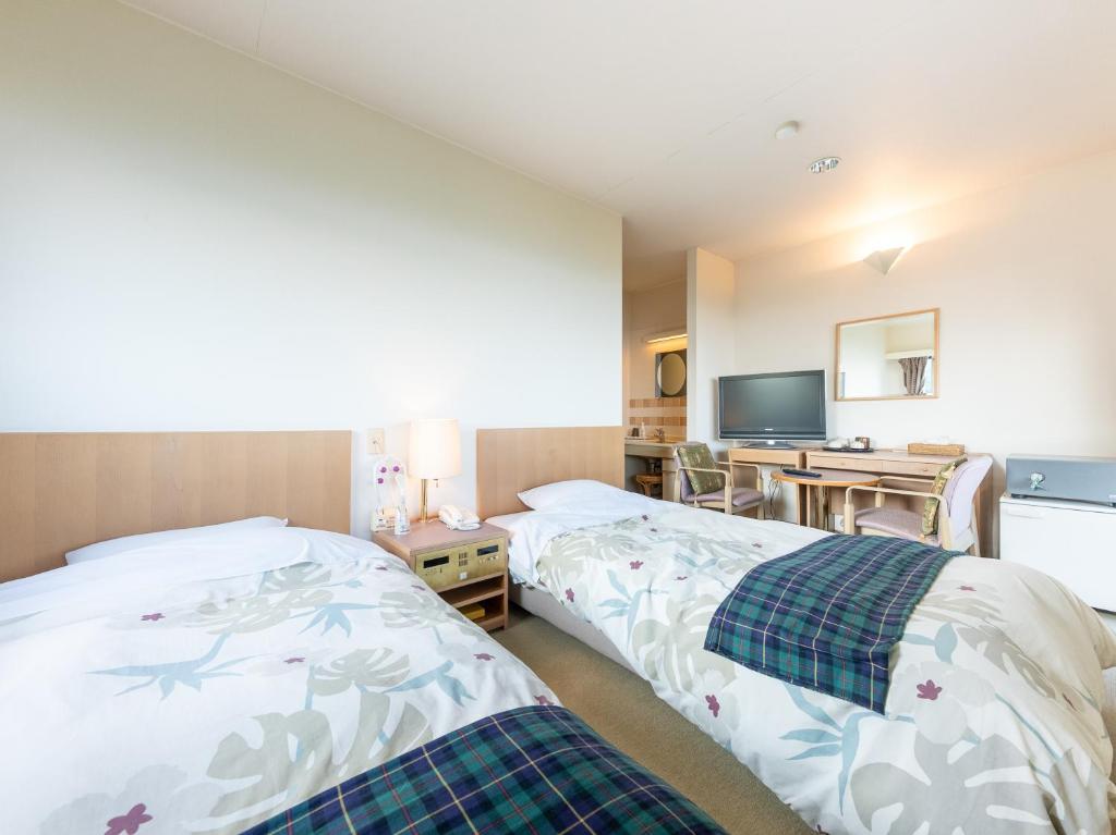 Postel nebo postele na pokoji v ubytování Tabist Hotel Iyashi no Sato