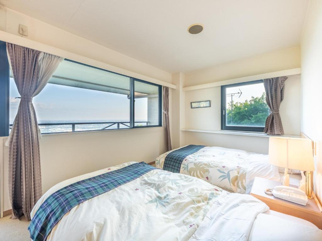 Postel nebo postele na pokoji v ubytování Tabist Hotel Iyashi no Sato