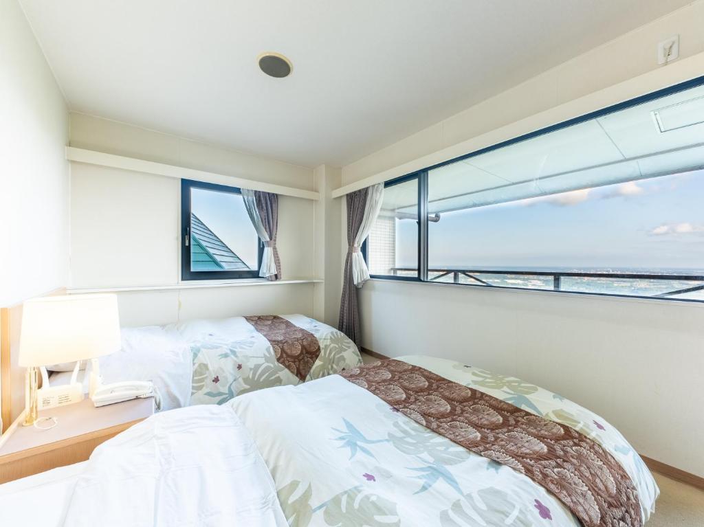Postel nebo postele na pokoji v ubytování Tabist Hotel Iyashi no Sato