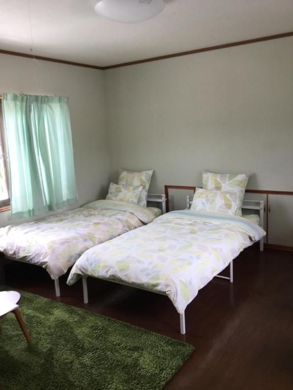 Postel nebo postele na pokoji v ubytování Guesthouse Yui