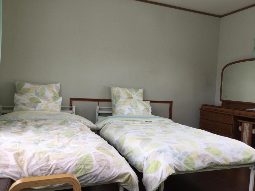 Postel nebo postele na pokoji v ubytování Guesthouse Yui