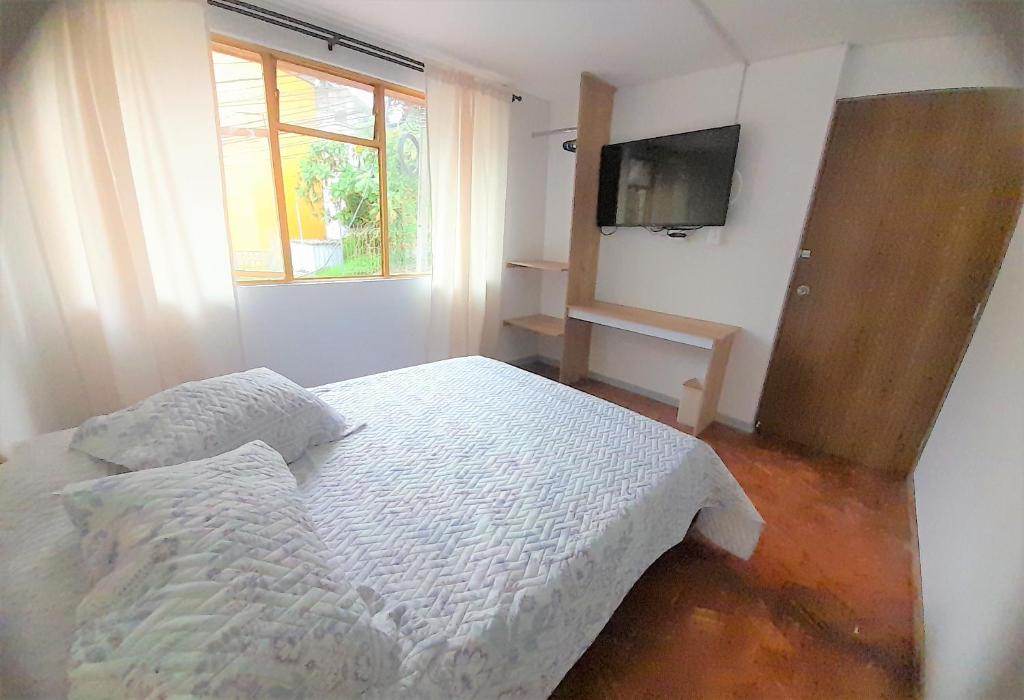 Postel nebo postele na pokoji v ubytování Casa Jaguar Manizales sector Cable