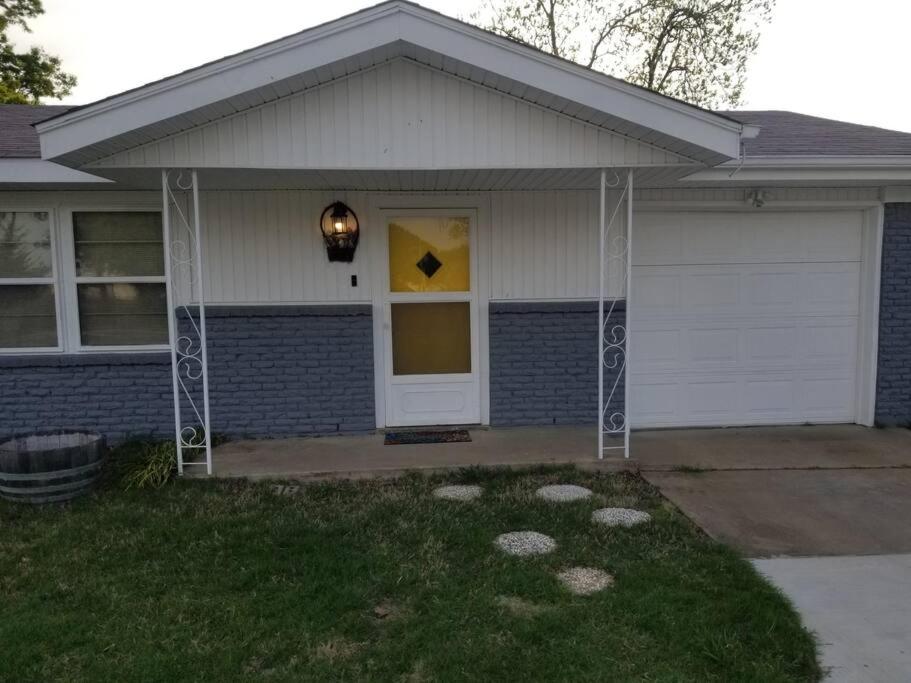 a house with a white door with a yellow window at *NEW*ENTIRE HOME IN ROSE DISTRICT*DINE*SHOP*FUN in Broken Arrow