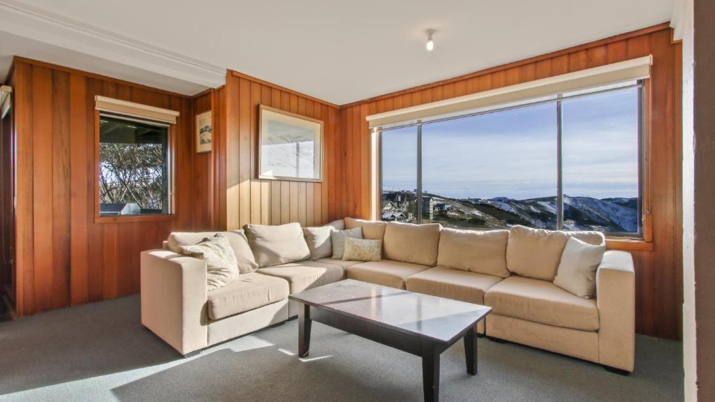 a living room with a couch and a table at 1750 Hotham 11 in Mount Hotham