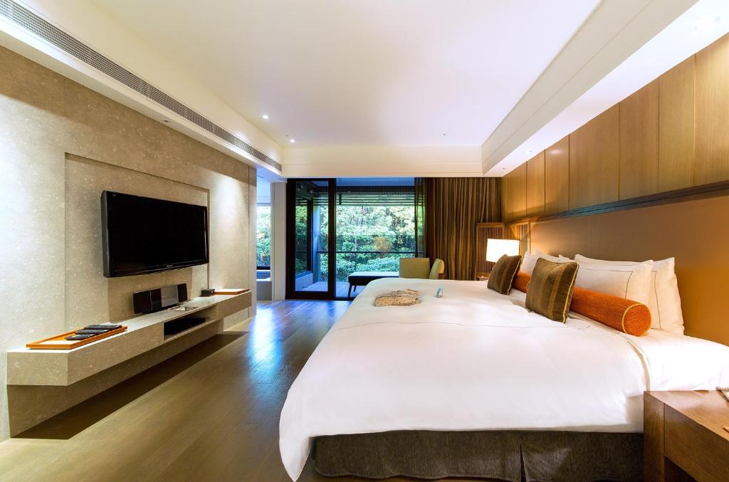 Postel nebo postele na pokoji v ubytování Grand View Resort Beitou