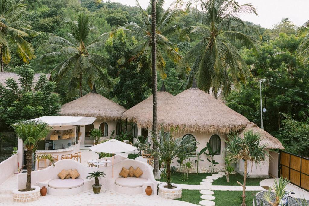 an image of a resort with palm trees at Tiu Oasis Lombok in Kuta Lombok