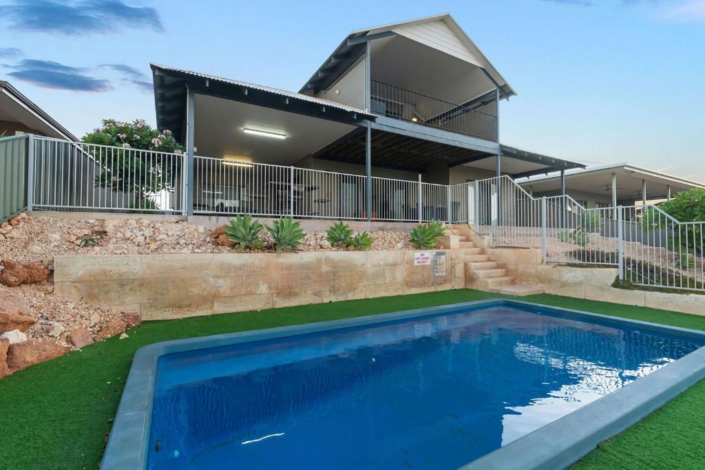 a house with a swimming pool in front of it at 3 Kestrel Place in Exmouth
