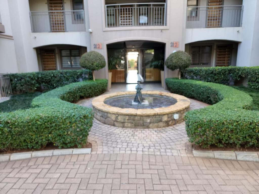 a courtyard with a fountain in the middle of a building at Homely Apartment, Hatfield, Unit-9 in Pretoria
