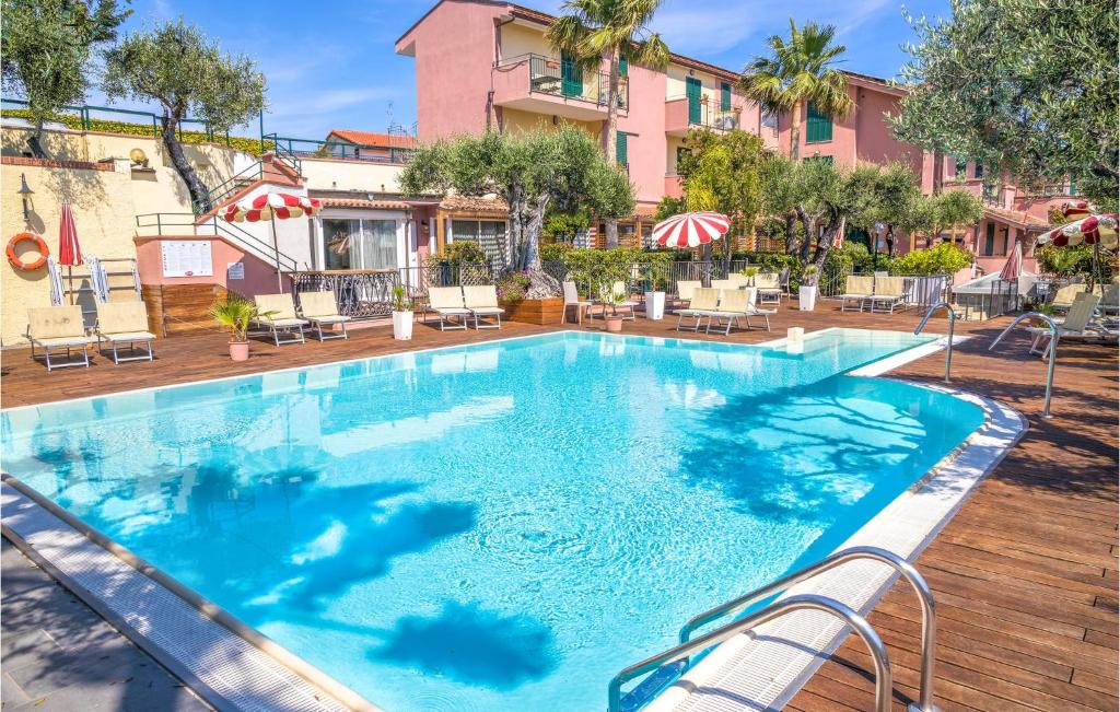 a swimming pool at a hotel with chairs and umbrellas at Lavanda trilo in Caramagna Ligure