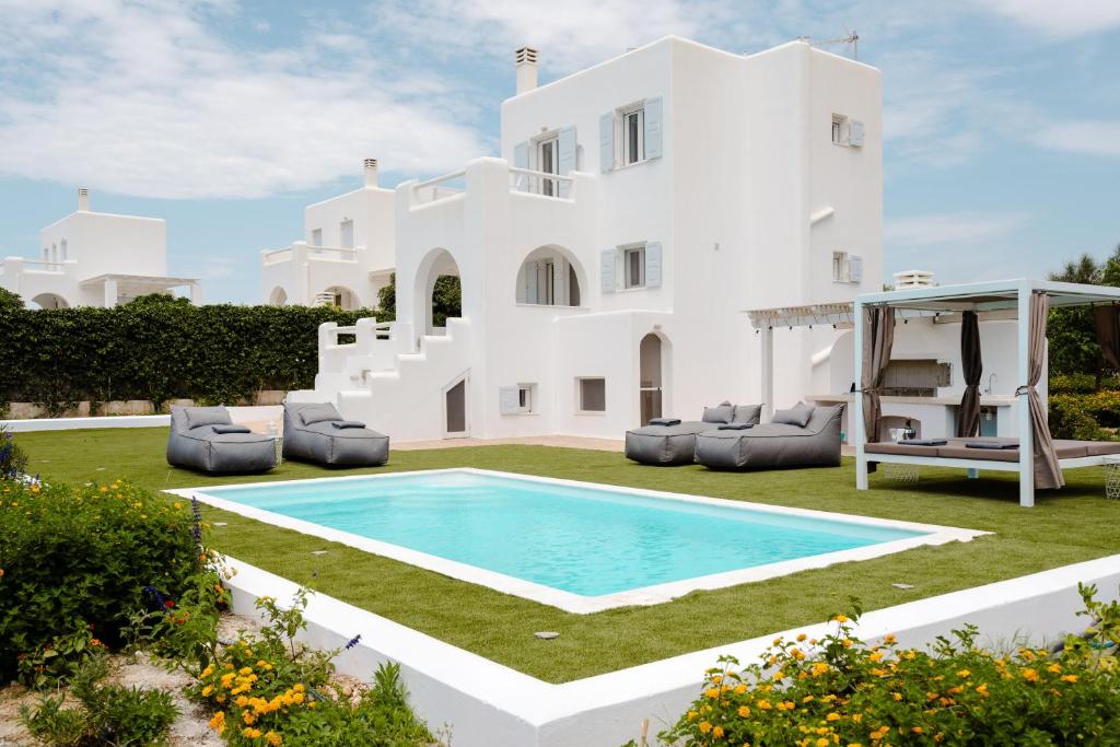 uma villa com piscina em frente a uma casa em Pyrgaki Beach Villa em Praia de Aliko