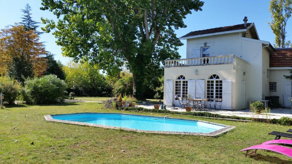ボルドーにあるChambres d'hôtes les Marronniersの庭にスイミングプールがある家