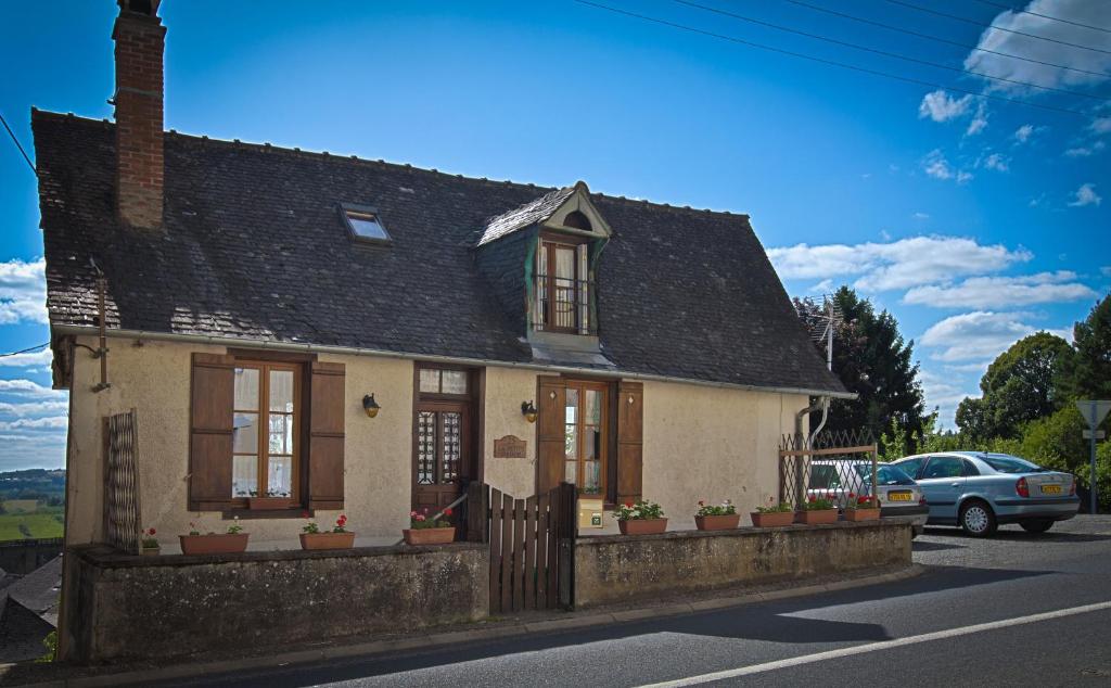 a small house with a fence in front of it at La Petite Maison, Vignols in Vignols