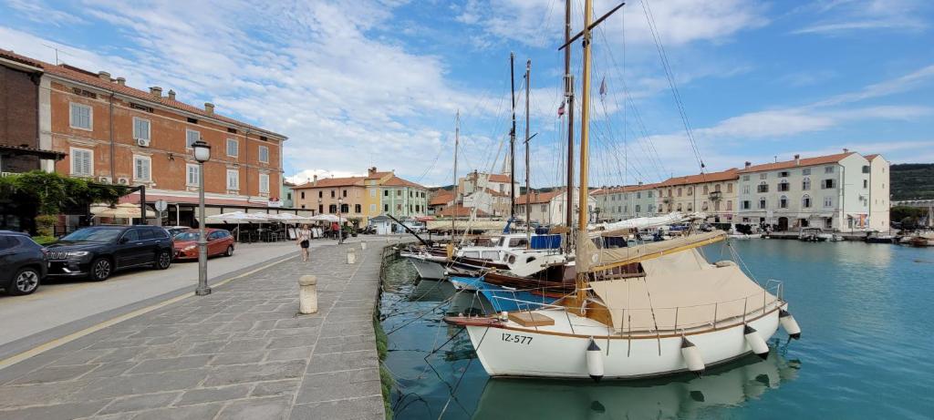 a boat is docked in the water in a city at Apartmaji Sonce Izola in Izola