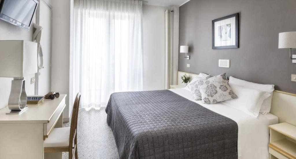 Postel nebo postele na pokoji v ubytování Hotel Carignano