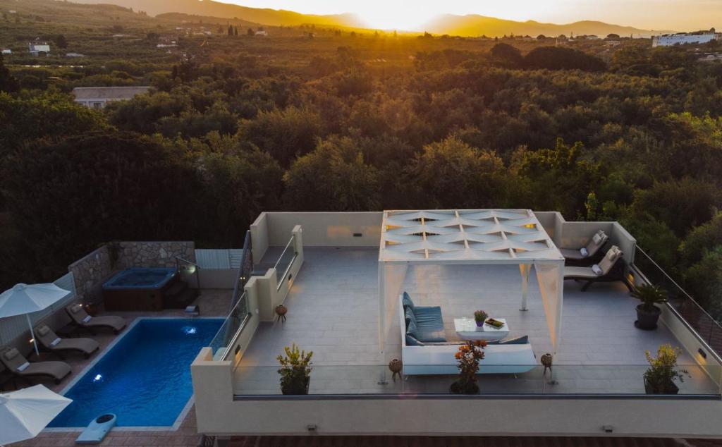 an aerial view of a house with a swimming pool at Fiorentinos Villa in Tragaki